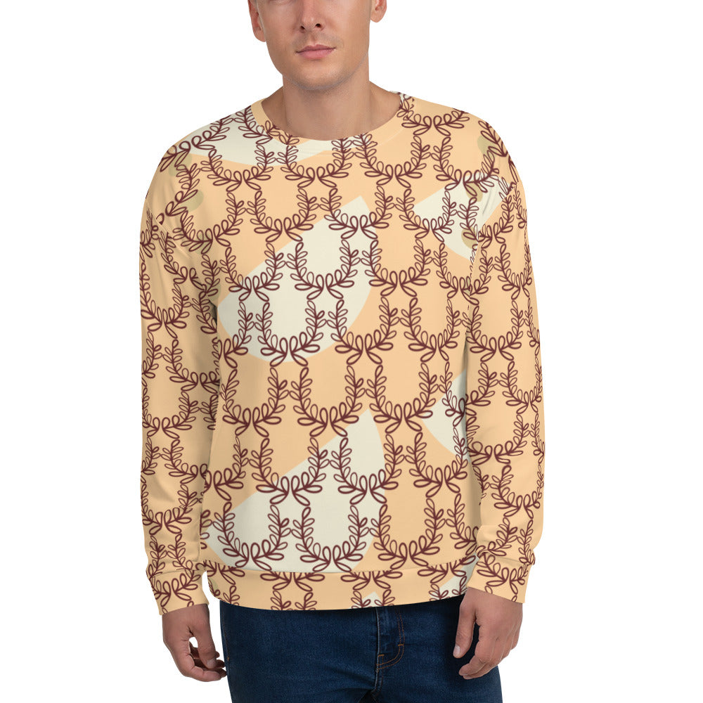 A man wearing a beige unisex sweatshirt with an all-over print of laurel leaves and crown frangipani.