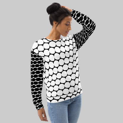 Woman wearing a black and white patterned sweater on a gray background