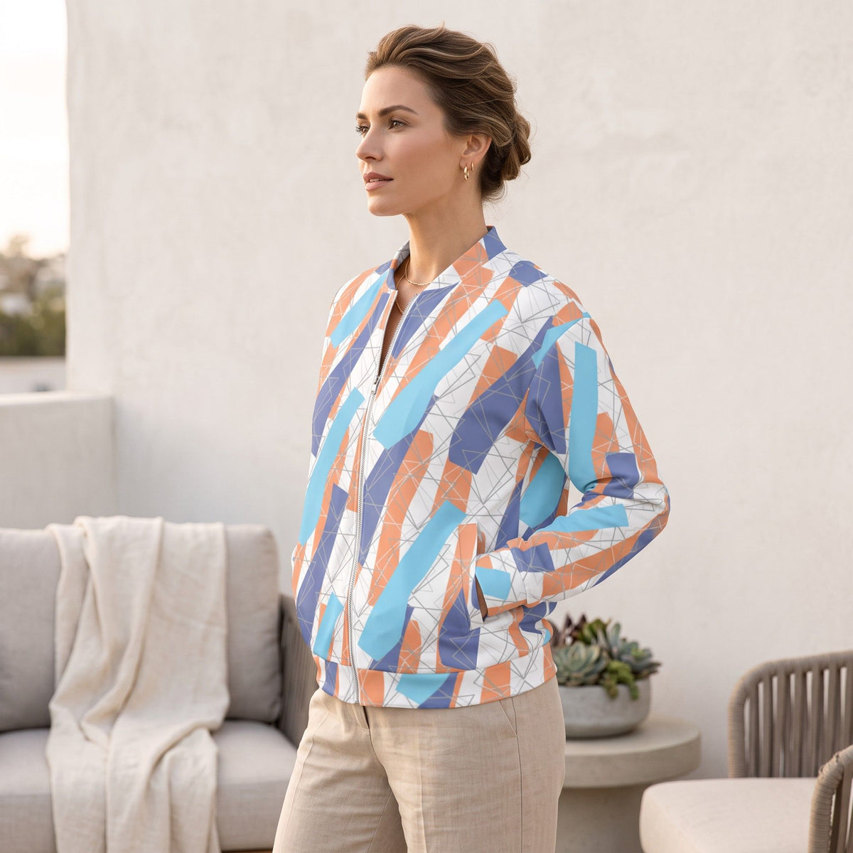 Good Wishes 365 unisex bomber jacket featuring a vibrant blue and orange abstract print with a silver YKK zipper.