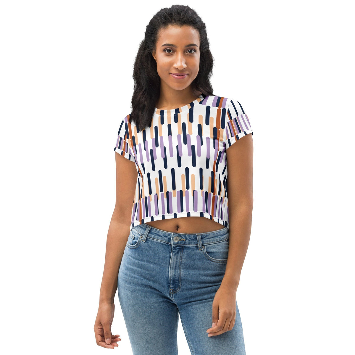 Good Wishes 365 model wearing a white crop tee with a colorful vertical dash all-over print and four-way stretch fabric.
