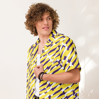 Good Wishes 365 short sleeve button down shirt with yellow and purple geometric print worn by a curly-haired man. All-over print, unisex button shirt, close side view. 