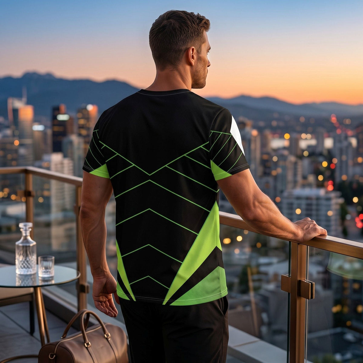 Good Wishes 365 black and neon green athletic training shirt with V-line graphic worn by a man on a city balcony.
