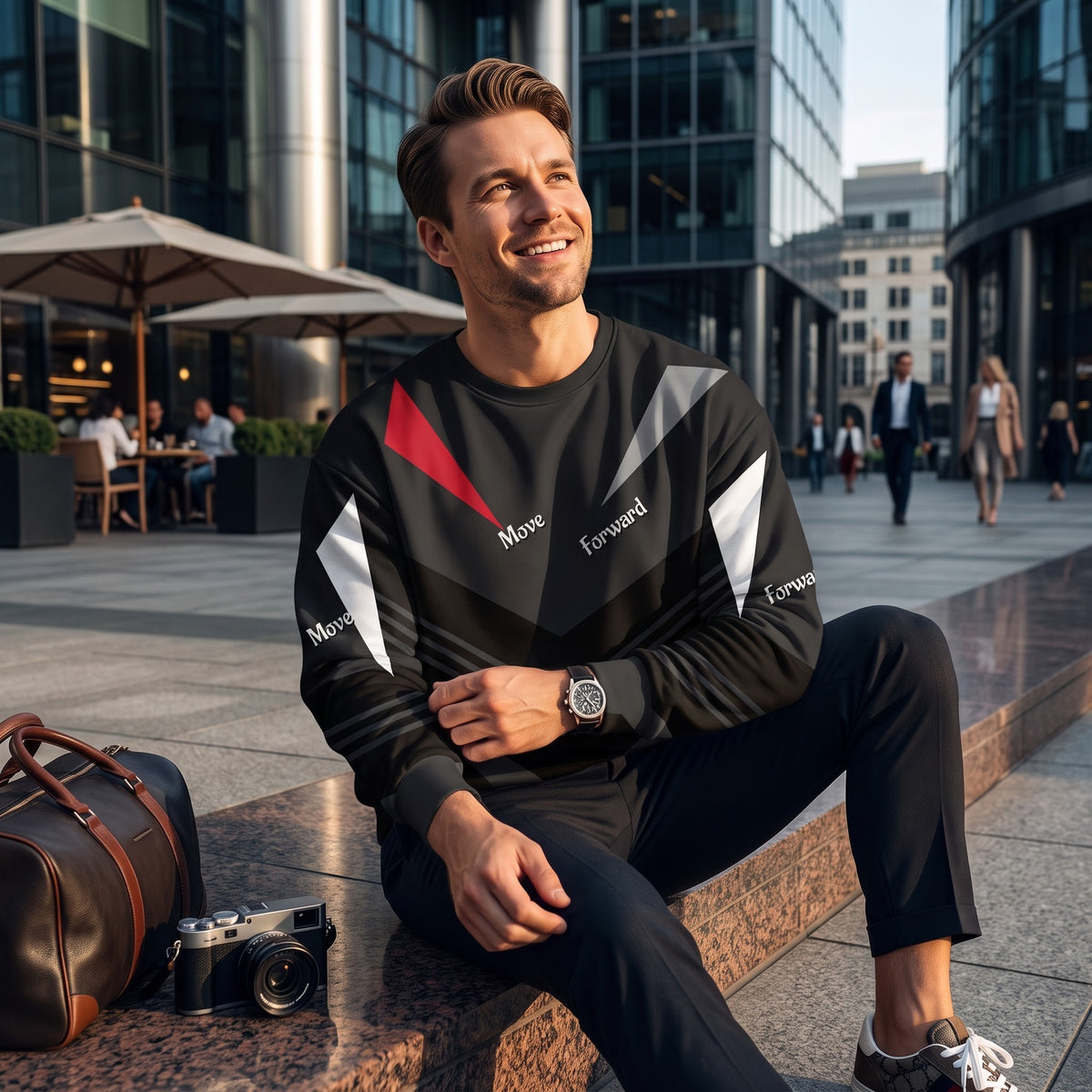 Good Wishes 365 black recycled sweatshirt with red and white V-line athletic print worn by a man in a city plaza.