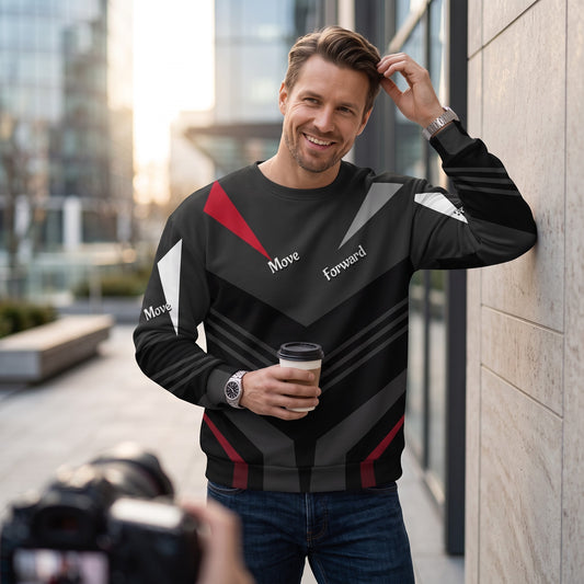 Good Wishes 365 black recycled sweatshirt with red and grey V-line print worn by a smiling man holding coffee