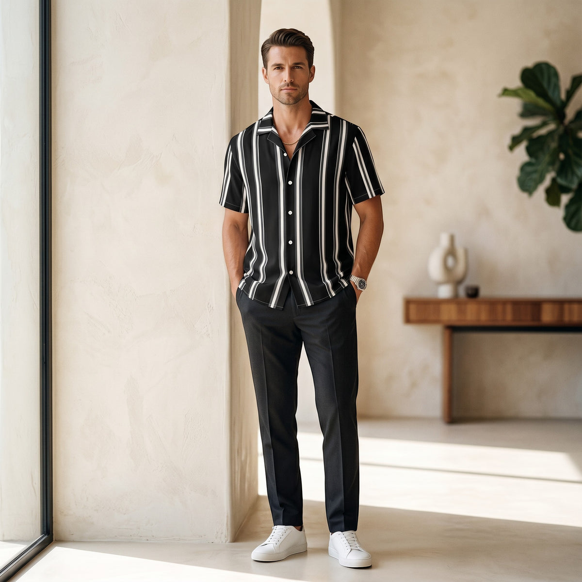 Good Wishes 365 black and white vertical striped short sleeve button-up shirt with camp collar on a male model.