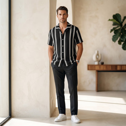 Good Wishes 365 black and white vertical striped short sleeve button-up shirt with camp collar on a male model.