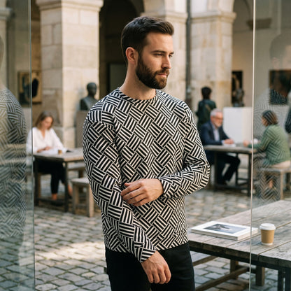 Good Wishes 365 unisex sweatshirt with a black and white geometric basketweave pattern worn by a man in a courtyard.