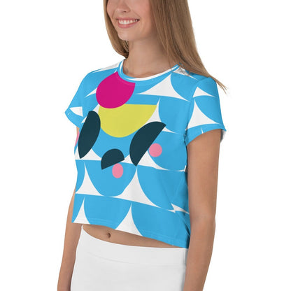 Good Wishes 365 sky blue crop tee with abstract geometric mushroom graphic in pink and yellow on a smiling model