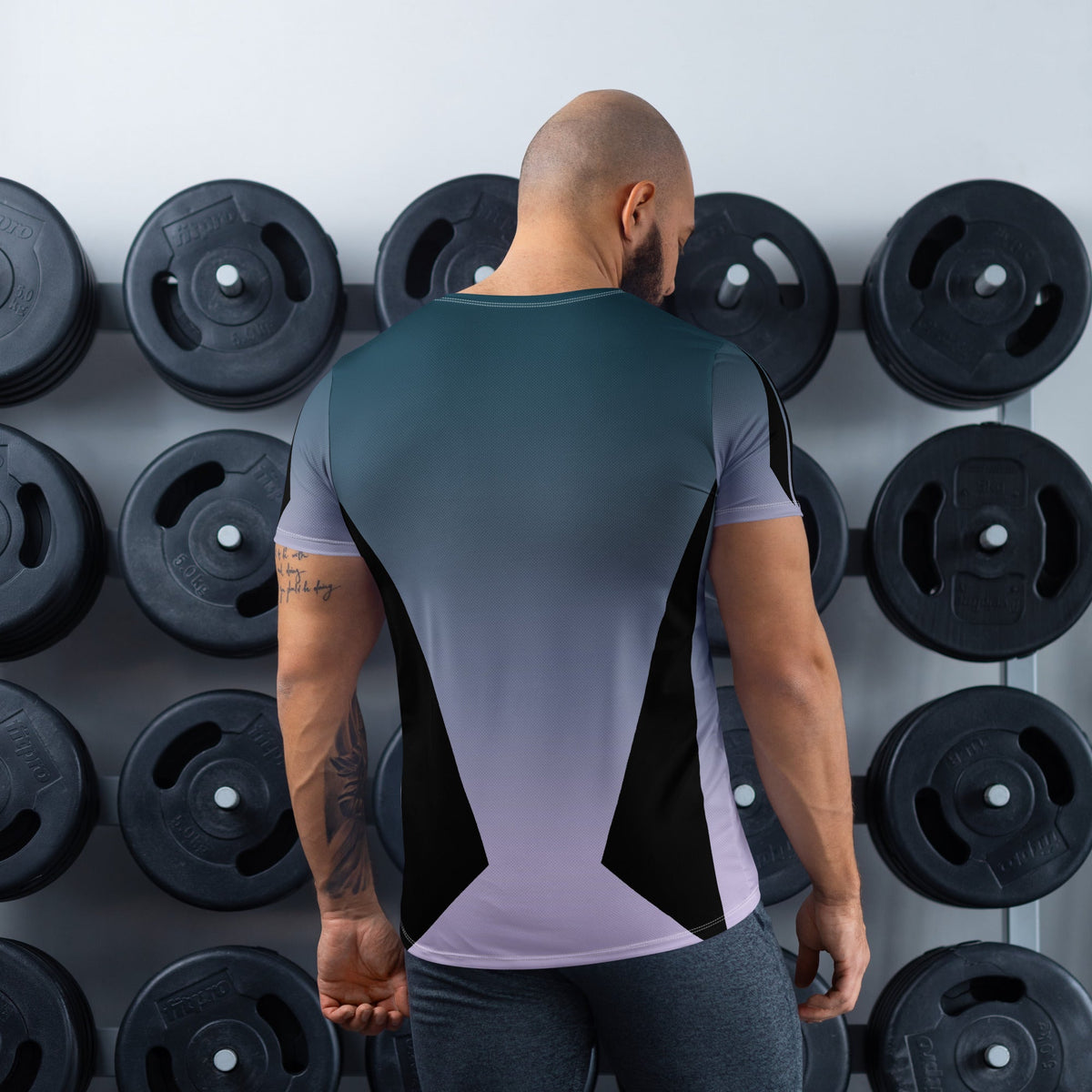 Good Wishes 365 men's athletic t-shirt with a blue gradient print, moisture-wicking fabric, back view in a gym.