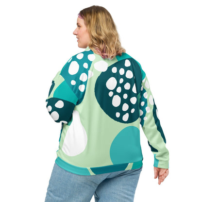 Good Wishes 365 unisex bomber jacket with abstract blue and mint green circular print worn by a woman from behind