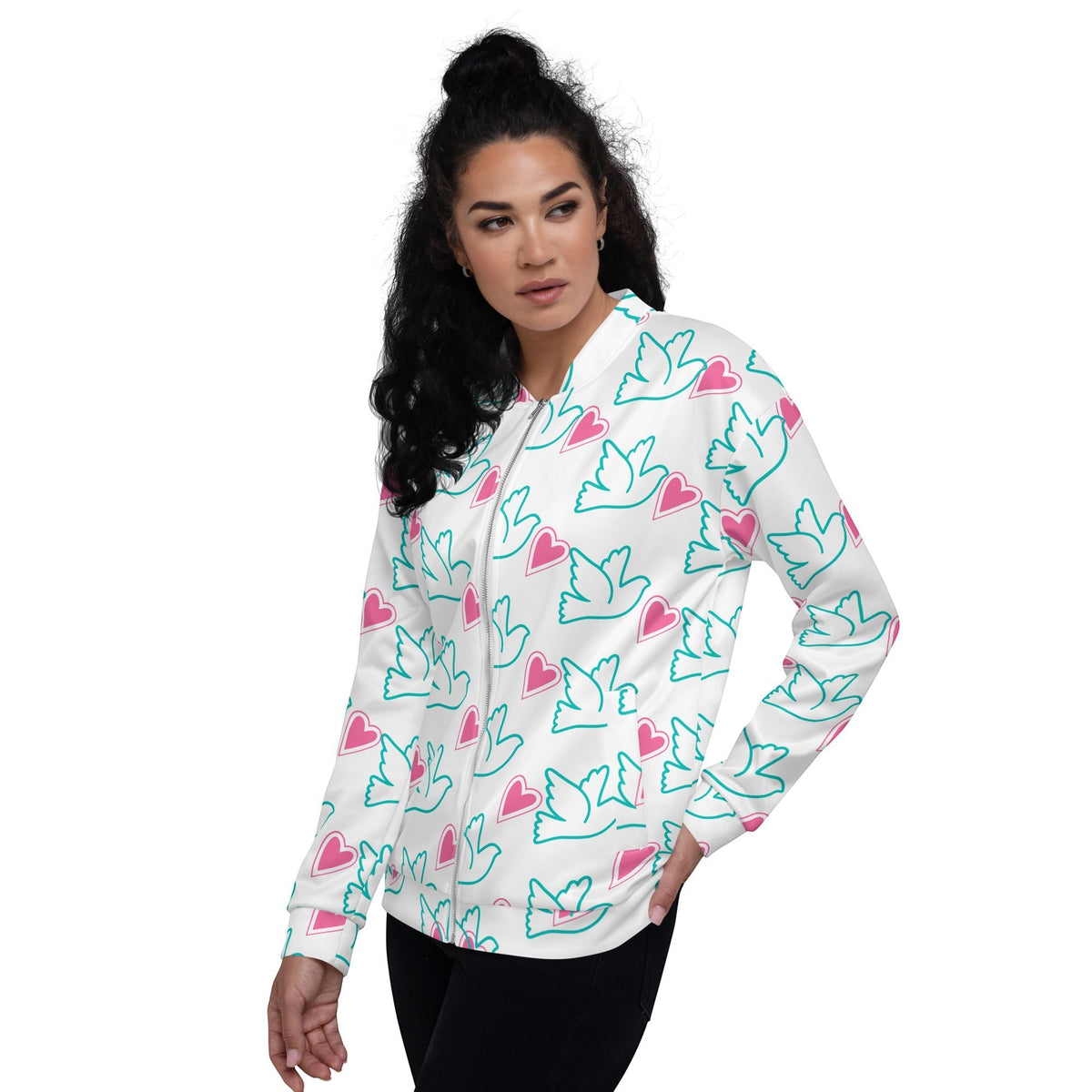 Good Wishes 365 bomber jacket with teal dove and pink heart print on white, worn by a woman with dark curly hair.