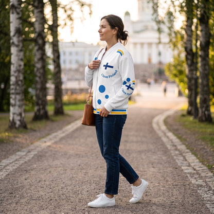 Good Wishes 365 unisex white bomber jacket with Finland-themed blue and yellow print, worn by a woman in a park.