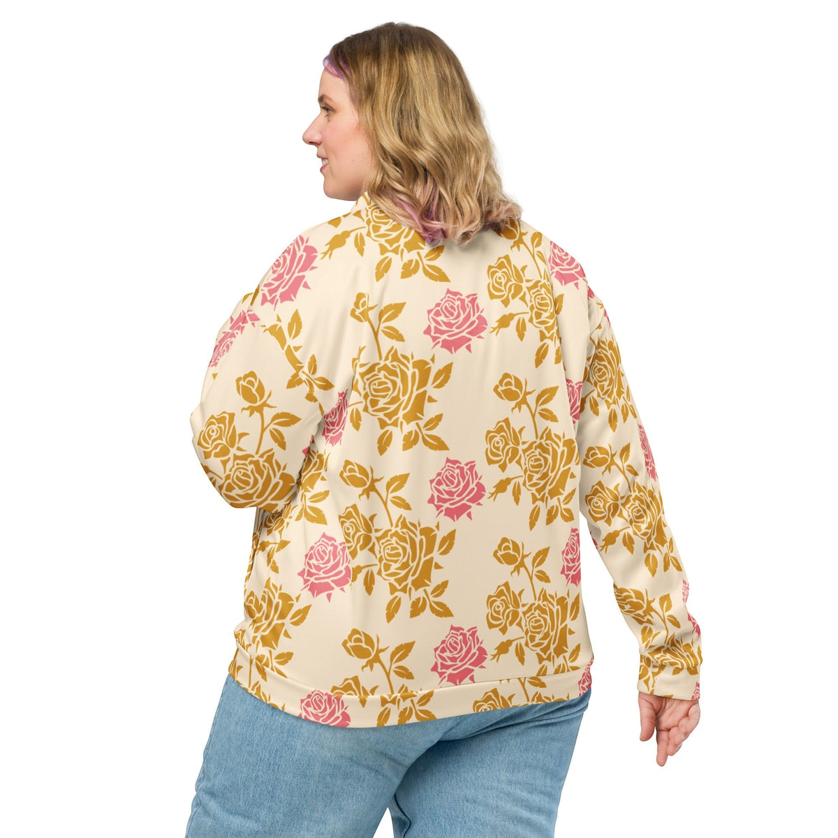 Good Wishes 365 unisex bomber jacket with cream base and vintage pink and gold rose print, back view on a woman.