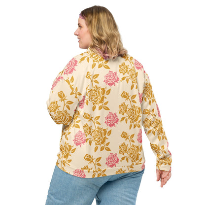 Good Wishes 365 unisex bomber jacket with cream base and vintage pink and gold rose print, back view on a woman.