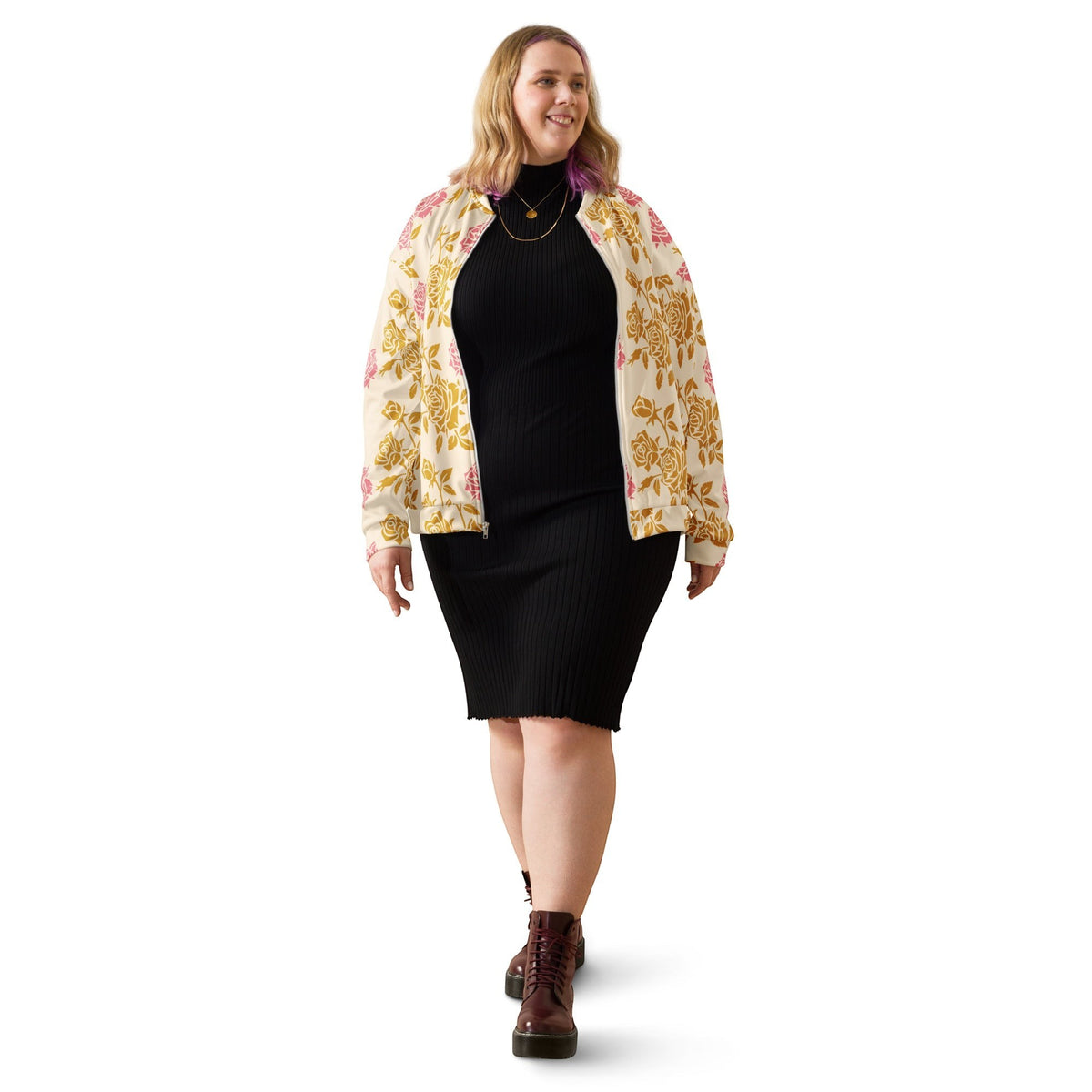 Good Wishes 365 cream bomber jacket with pink and gold rose print worn by a smiling woman over a black ribbed dress