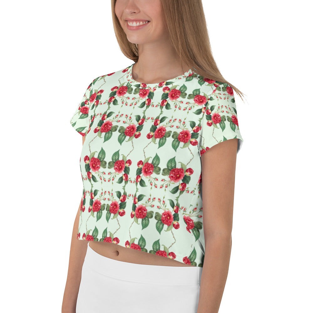 Good Wishes 365 mint green crop tee with a red rose geometric grid pattern worn by a smiling woman