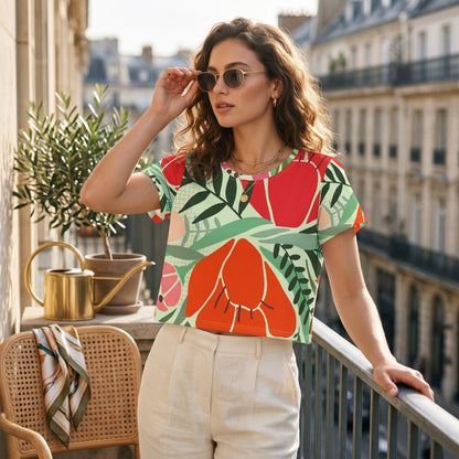 Good Wishes 365 mint crop tee with red and orange floral print, worn by a woman on a balcony in a city setting.