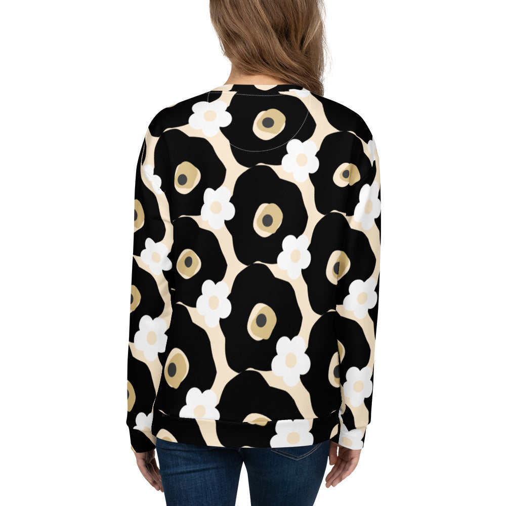 Good Wishes 365 recycled sweatshirt with black, white, and beige floral print, shown from the back on a woman.