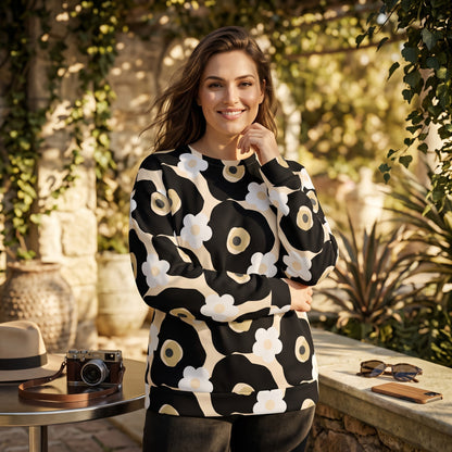Good Wishes 365 recycled sweatshirt with black, white, and beige floral print worn by a smiling woman outdoors.