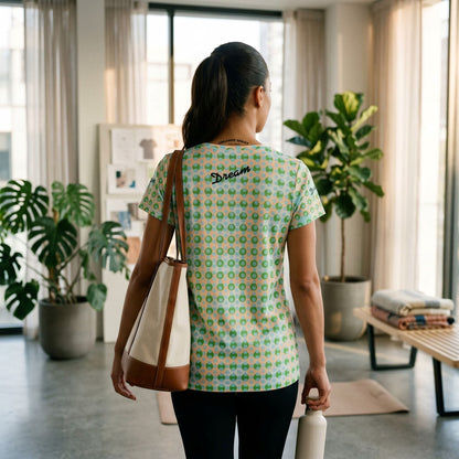 Good Wishes 365 athletic t-shirt with green and blue geometric print, featuring Dream logo on back, worn by a woman.