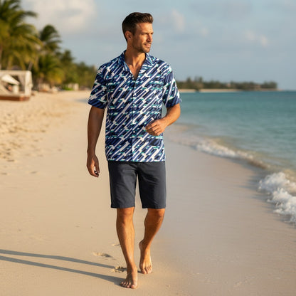 Good Wishes 365 men's mariner blue geometric short sleeve button down shirt worn by a man walking on a sandy beach.