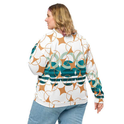 Good Wishes 365 bomber jacket with geometric star pattern in teal, sage, and ochre on a woman wearing blue jeans.