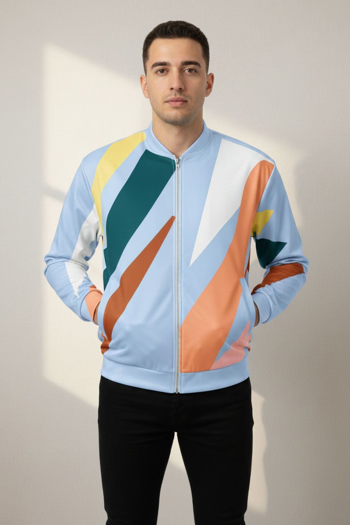 Good Wishes 365 unisex bomber jacket with abstract geometric print in pastel blue and earth tones on a male model