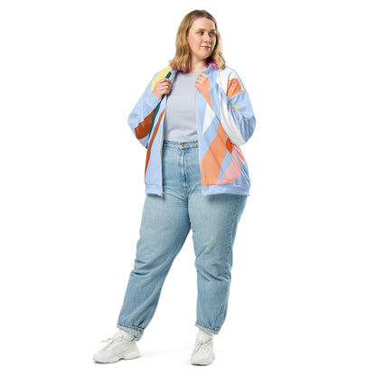 Good Wishes 365 women's bomber jacket with pastel and earth tone abstract geometric print, worn with jeans and sneakers.