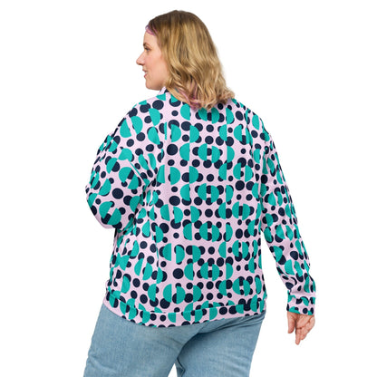 Woman wearing a Good Wishes 365 bomber jacket with a navy polka dot and Irish blue semi-circle print on light pink