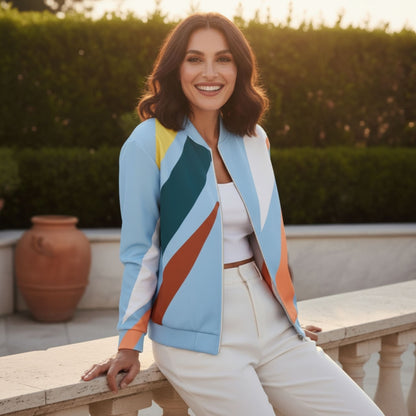A woman wearing a Good Wishes 365 bomber jacket with a pastel and earth-tone geometric print, styled with white pants.