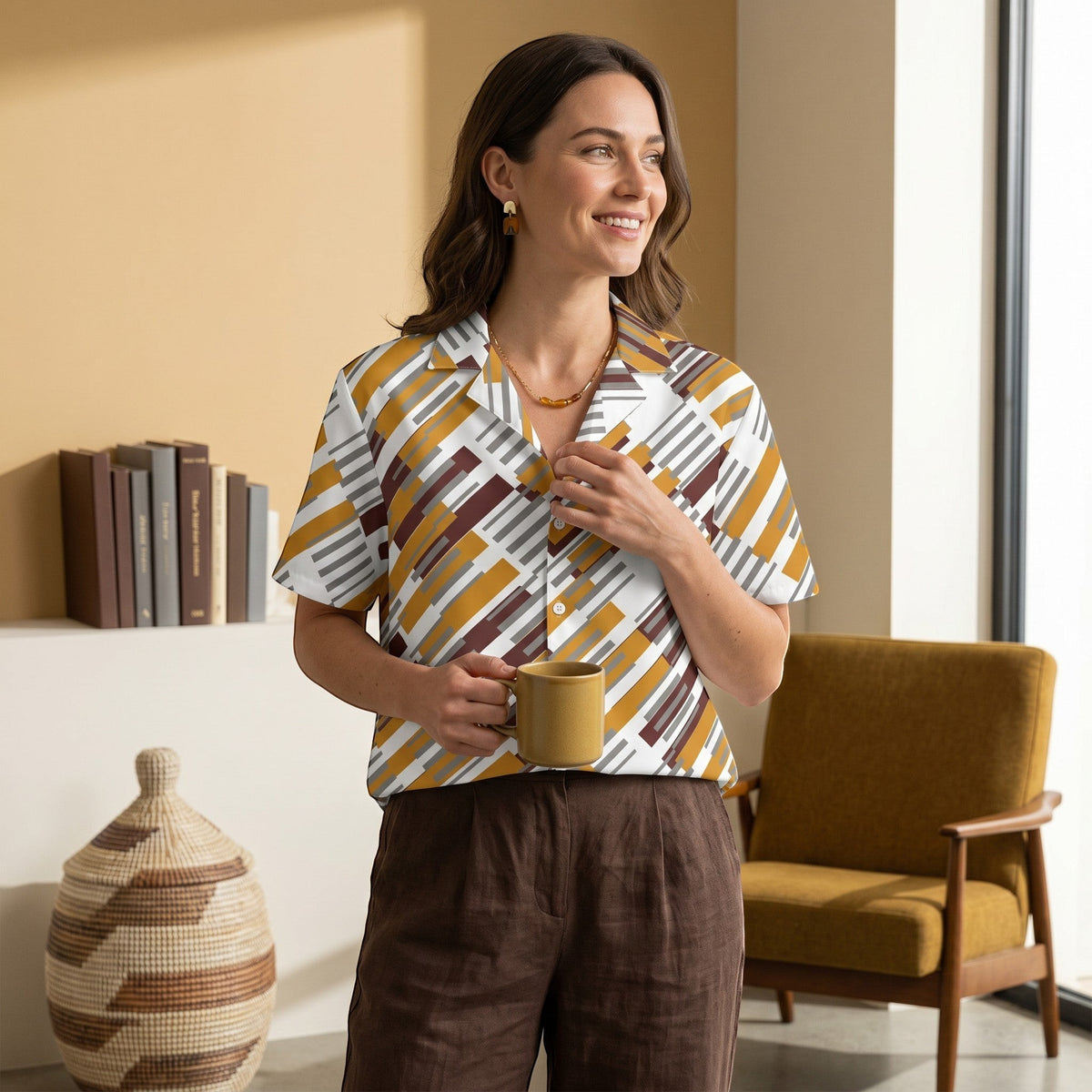 Good Wishes 365 unisex button shirt with a geometric pattern in white, yellow, and brown, worn by a smiling woman.