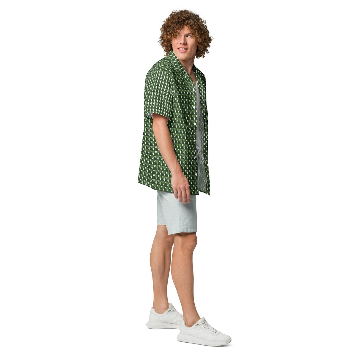 Good Wishes 365 men's short sleeve button shirt in forest green with a geometric triangle camo print, worn with shorts.
