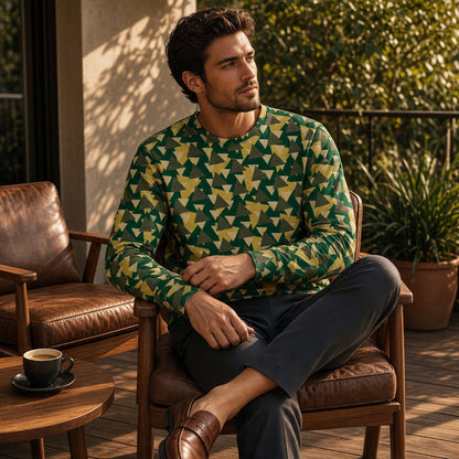 Good Wishes 365 unisex sweatshirt with a green and yellow geometric camo print, worn by a man on a sunny patio.