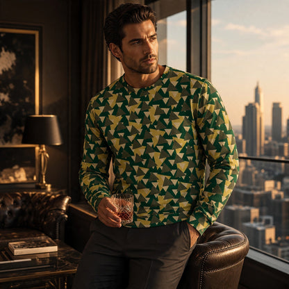 Man wearing a Good Wishes 365 geometric camo print sweatshirt in green and yellow with ribbed cuffs in a city loft.