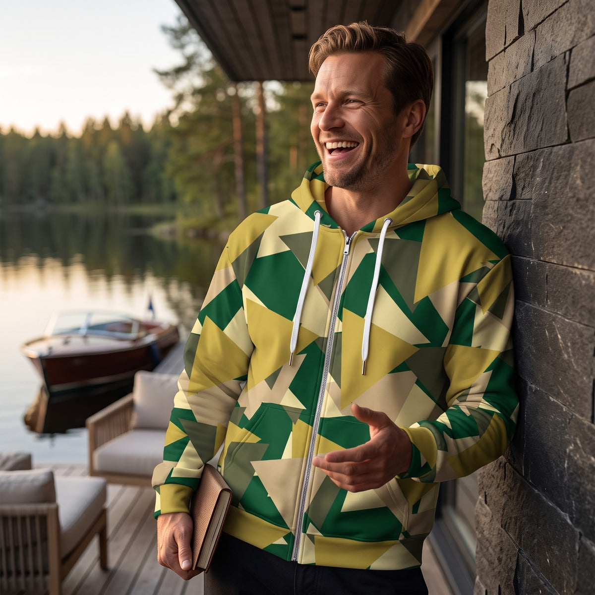 Man wearing a Good Wishes 365 geometric camo zip hoodie with a brushed fleece interior on a lakeside deck.