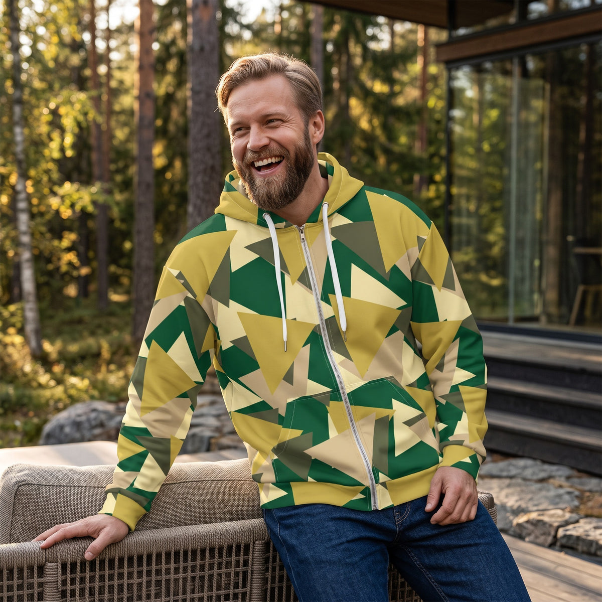 Good Wishes 365 men's zip hoodie featuring a geometric camo print in green, yellow, and tan, worn by a smiling man.