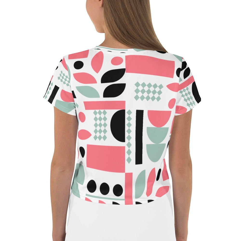 Good Wishes 365 crop tee featuring a geometric pattern in pastel pink, mint green, and black on a white background.