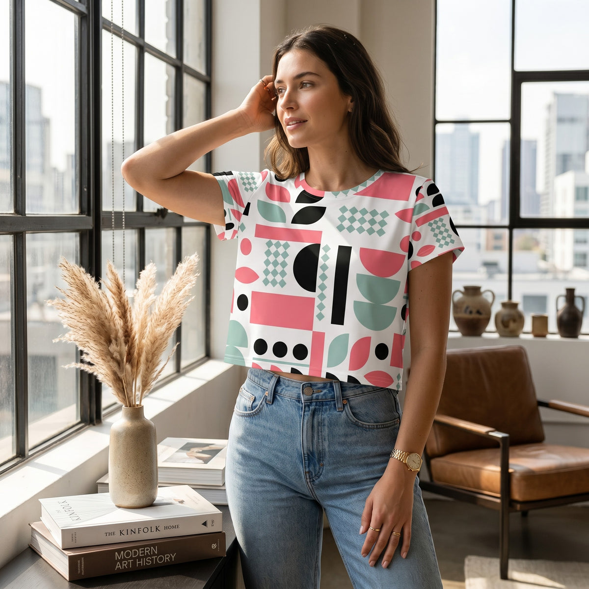 Good Wishes 365 crop tee with mint, red, and black geometric print worn by a woman in a bright, modern room.