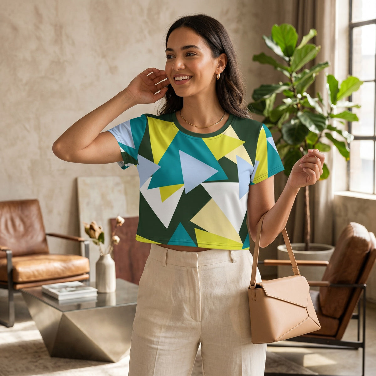 Good Wishes 365 crop tee with geometric triangle print in green, yellow, and blue, worn by a smiling woman.