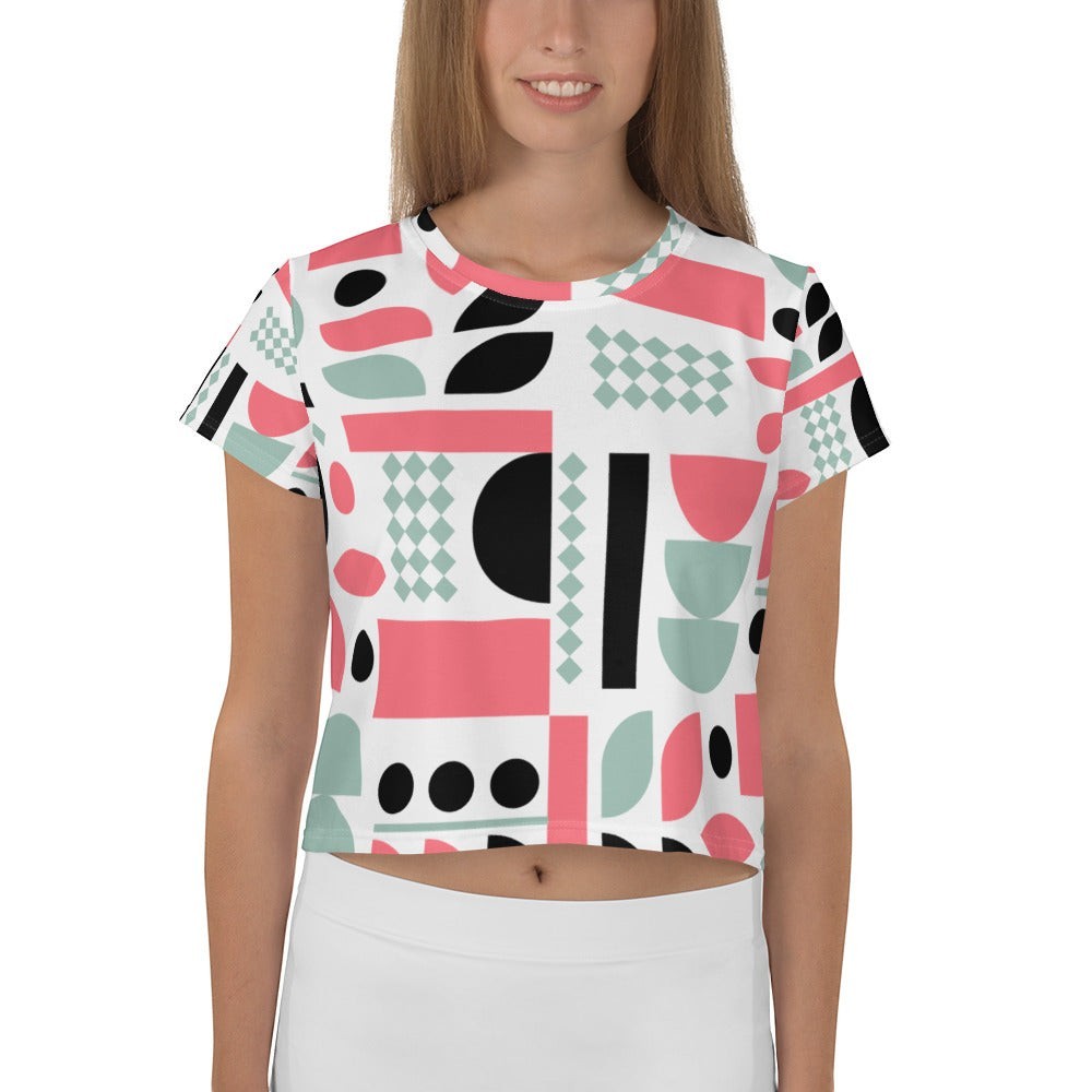 Model wearing a Good Wishes 365 crop tee with a pink, mint, and black geometric abstract print and crew neckline.