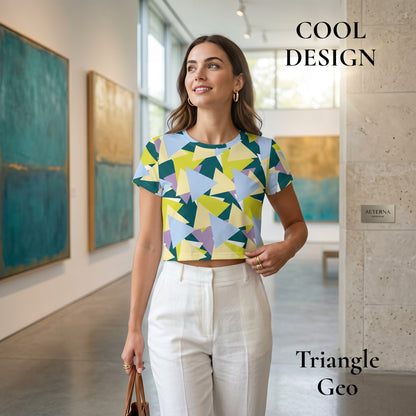 Good Wishes 365 crop tee with geometric triangle print in blue, yellow, and green, worn by a woman in an art gallery.