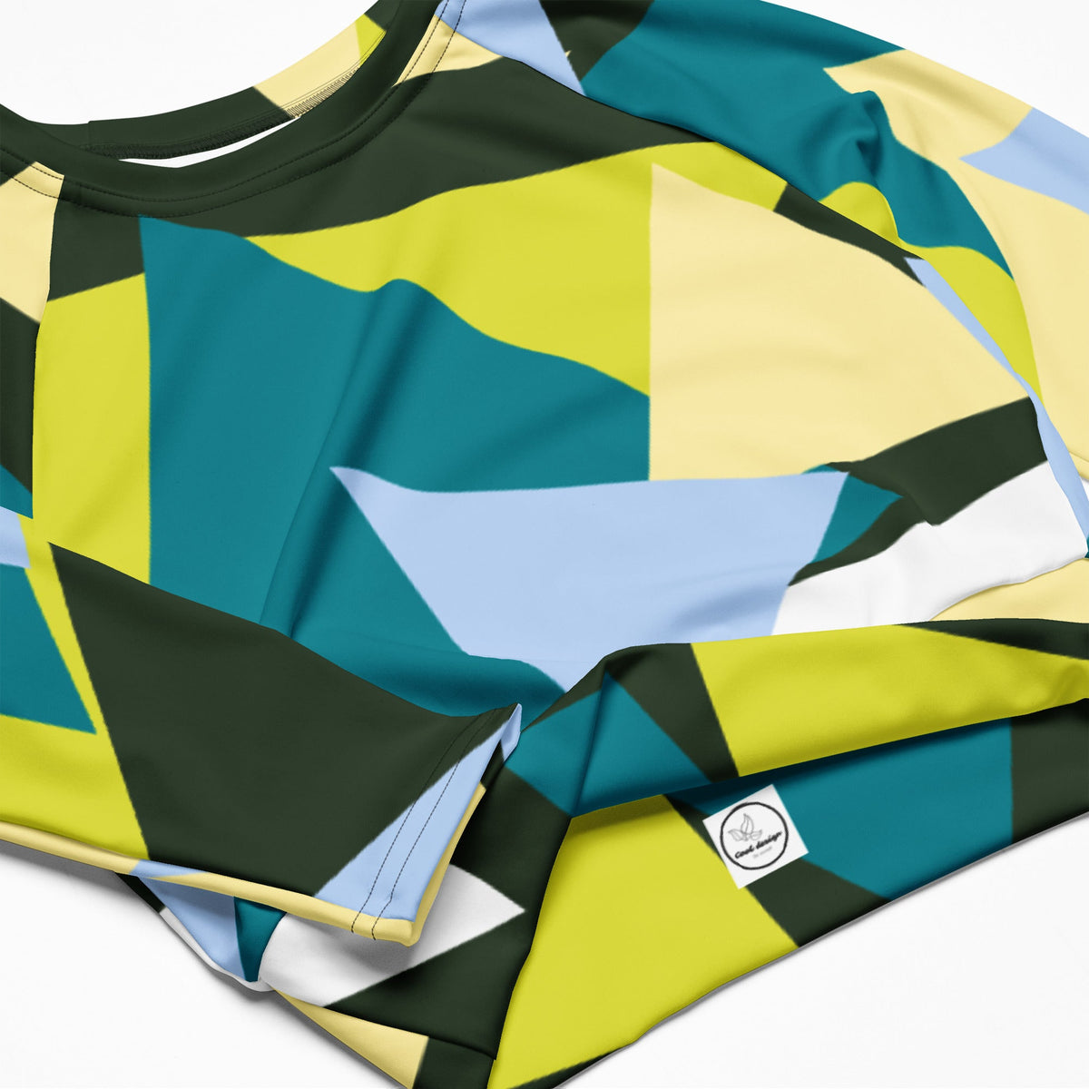 Good Wishes 365 long-sleeve crop top in recycled fabric with a geometric triangle print in green, lime, and blue.