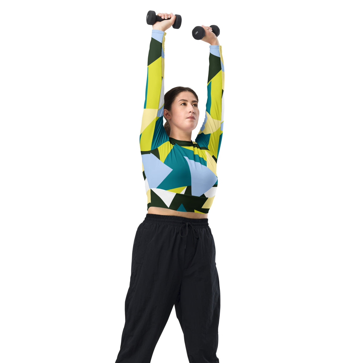 Good Wishes 365 long-sleeve crop top with geometric print in green, lime, and blue worn by a woman lifting dumbbells.