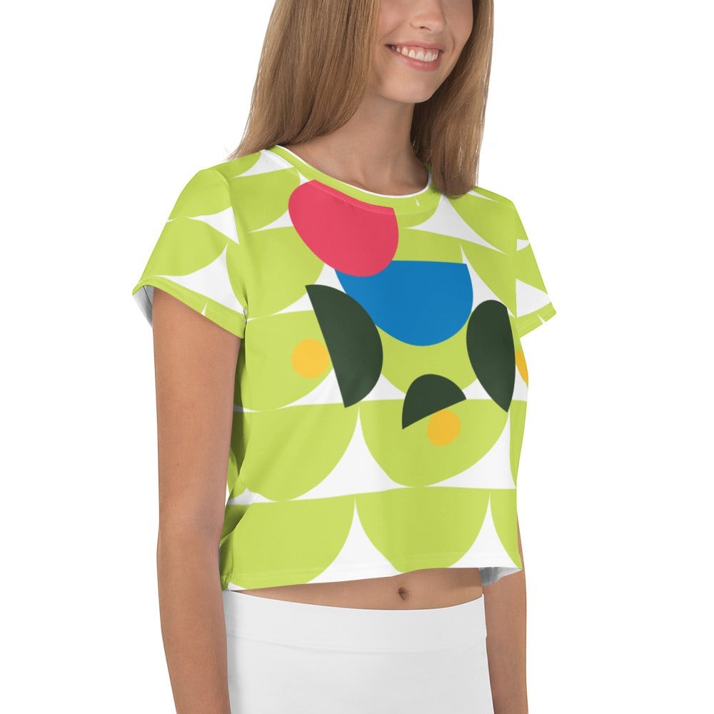 Good Wishes 365 lime green crop tee with abstract geometric mushroom graphic in pink, blue, and forest green.