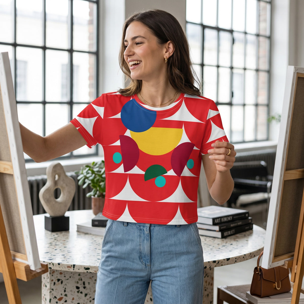 Good Wishes 365 crop tee with red geometric mushroom print on a woman painting in a bright studio