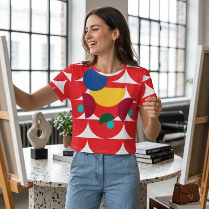 Good Wishes 365 crop tee with red geometric mushroom print on a woman painting in a bright studio
