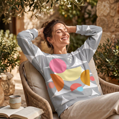Good Wishes 365 recycled sweatshirt with silver geometric mushroom print worn by a smiling woman sitting outdoors.