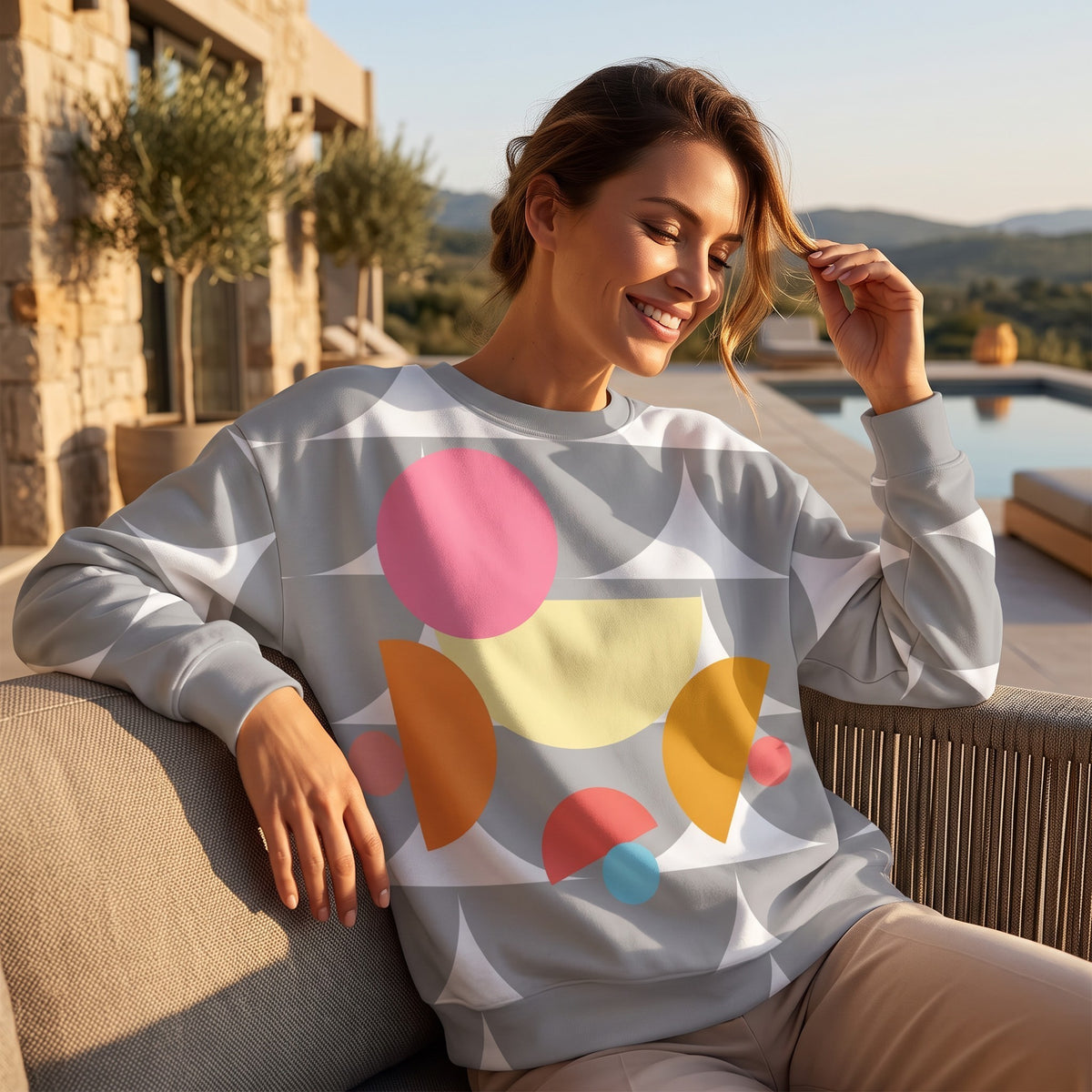 Good Wishes 365 recycled sweatshirt with silver and colorful geometric mushroom print worn by a smiling woman outdoors