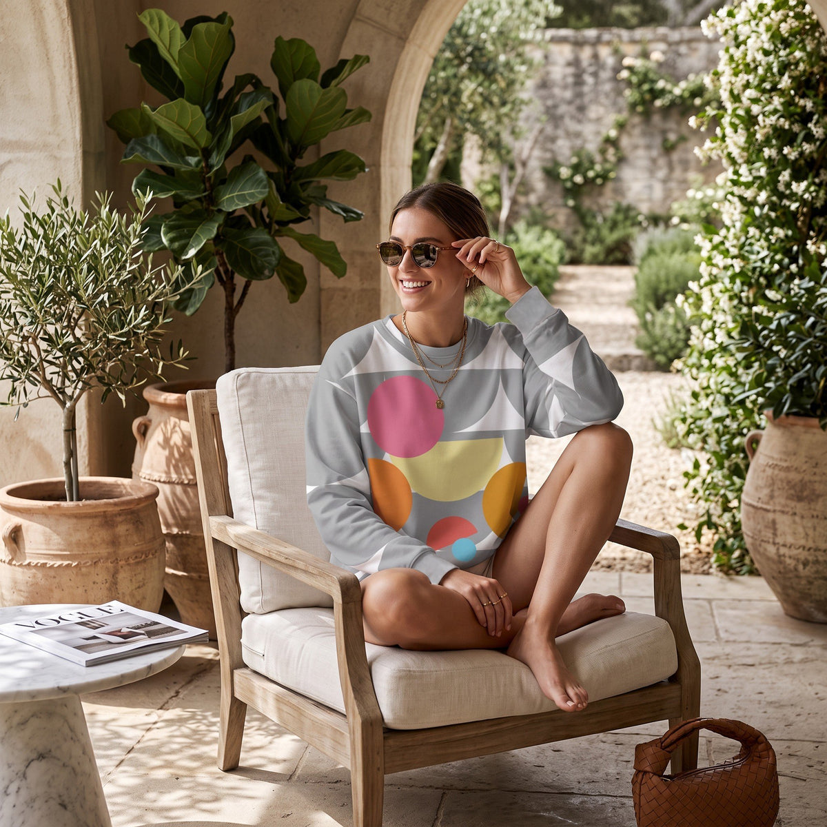 Good Wishes 365 recycled sweatshirt with silver geometric mushroom print worn by a woman in a sunny garden setting.
