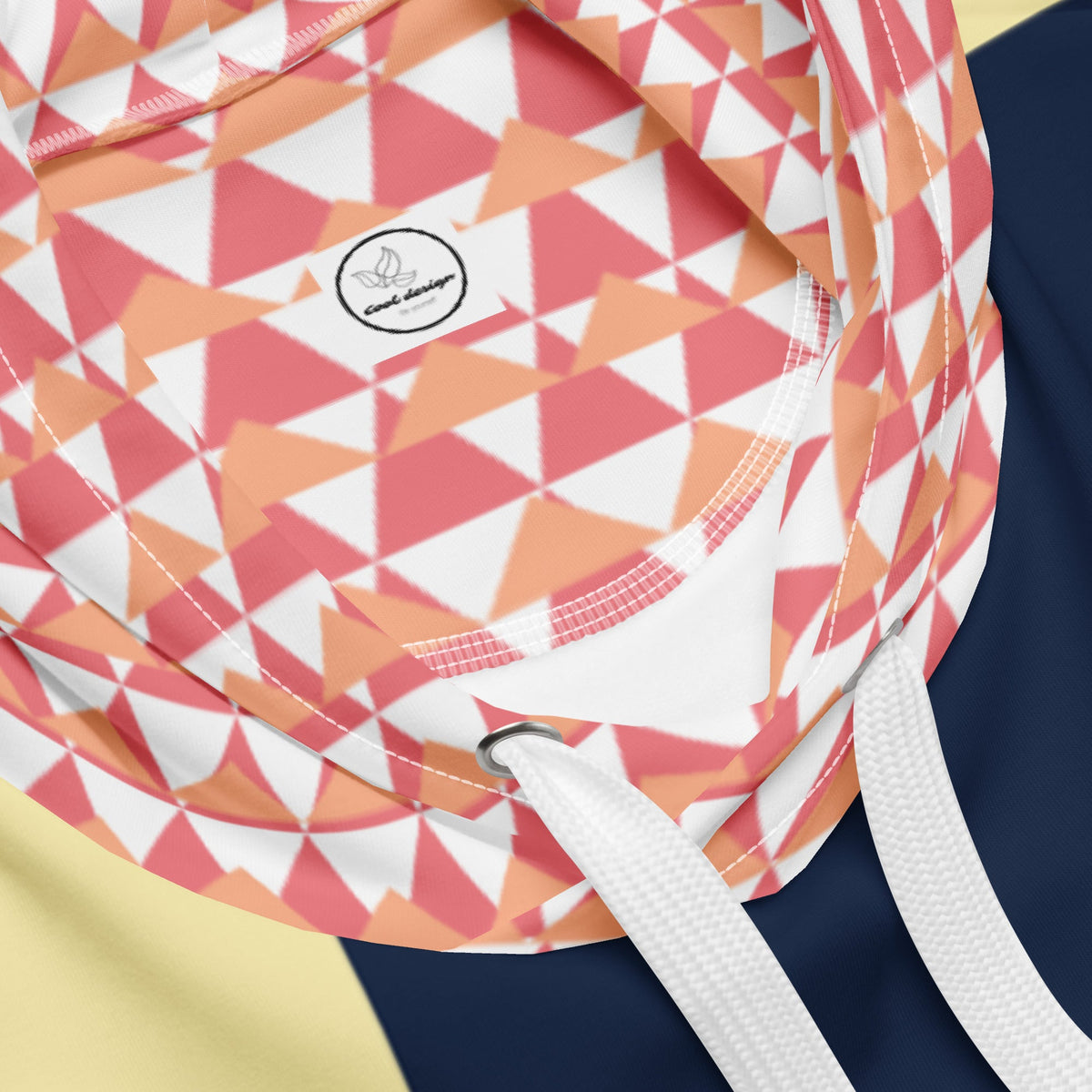 Good Wishes 365 unisex hoodie featuring a vibrant pink and orange geometric triangle print on the double-lined hood.